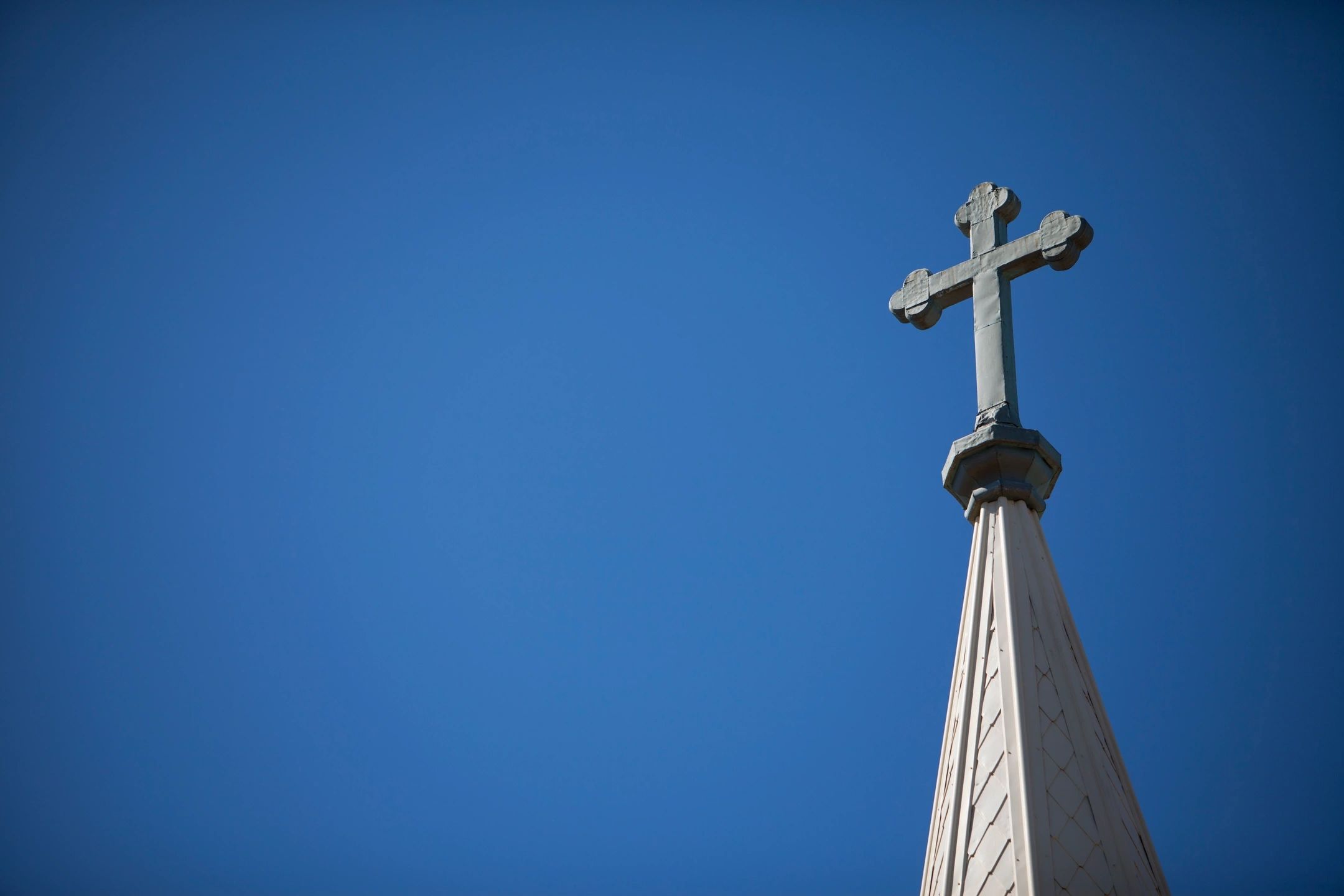 Church cross against blue sky